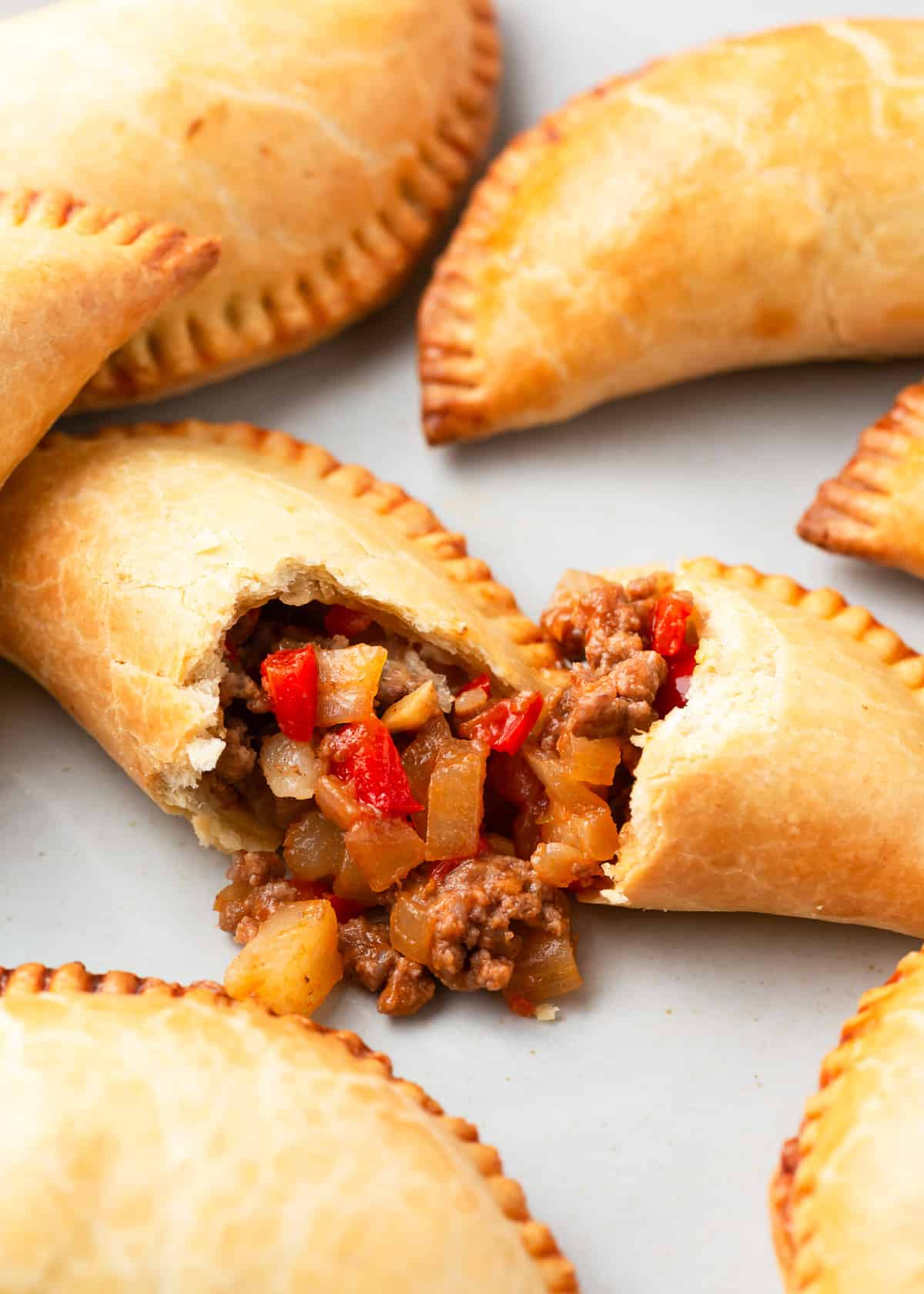 Beef empanadas on a white plate.