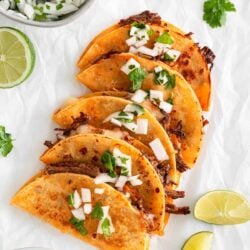 Birria tacos on a piece of parchment paper.