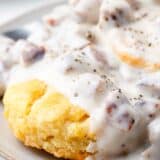 Biscuits and gravy on a plate.