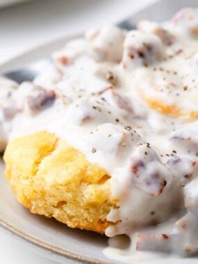 Biscuits and gravy on a plate.