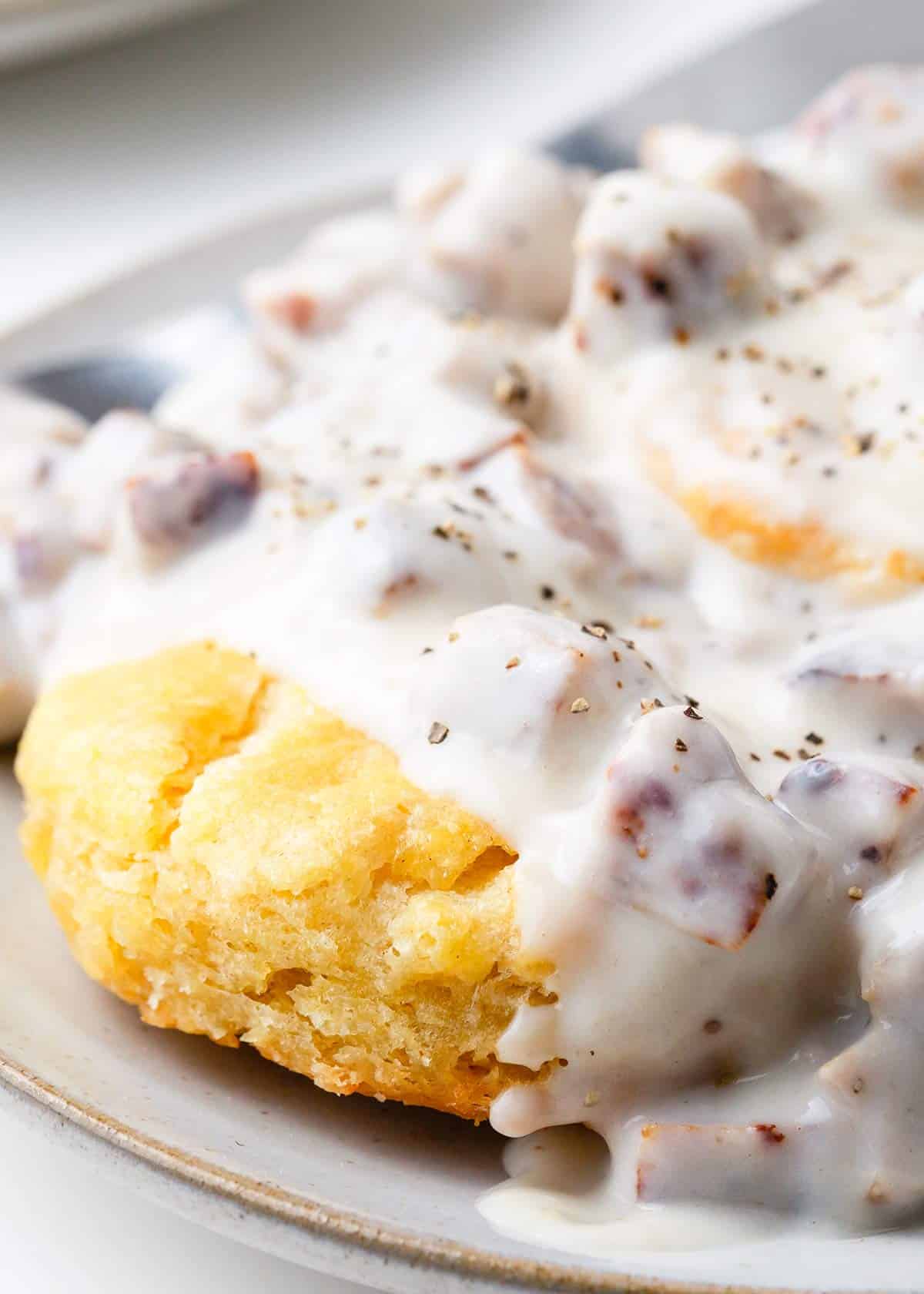 Biscuits and gravy on a plate.