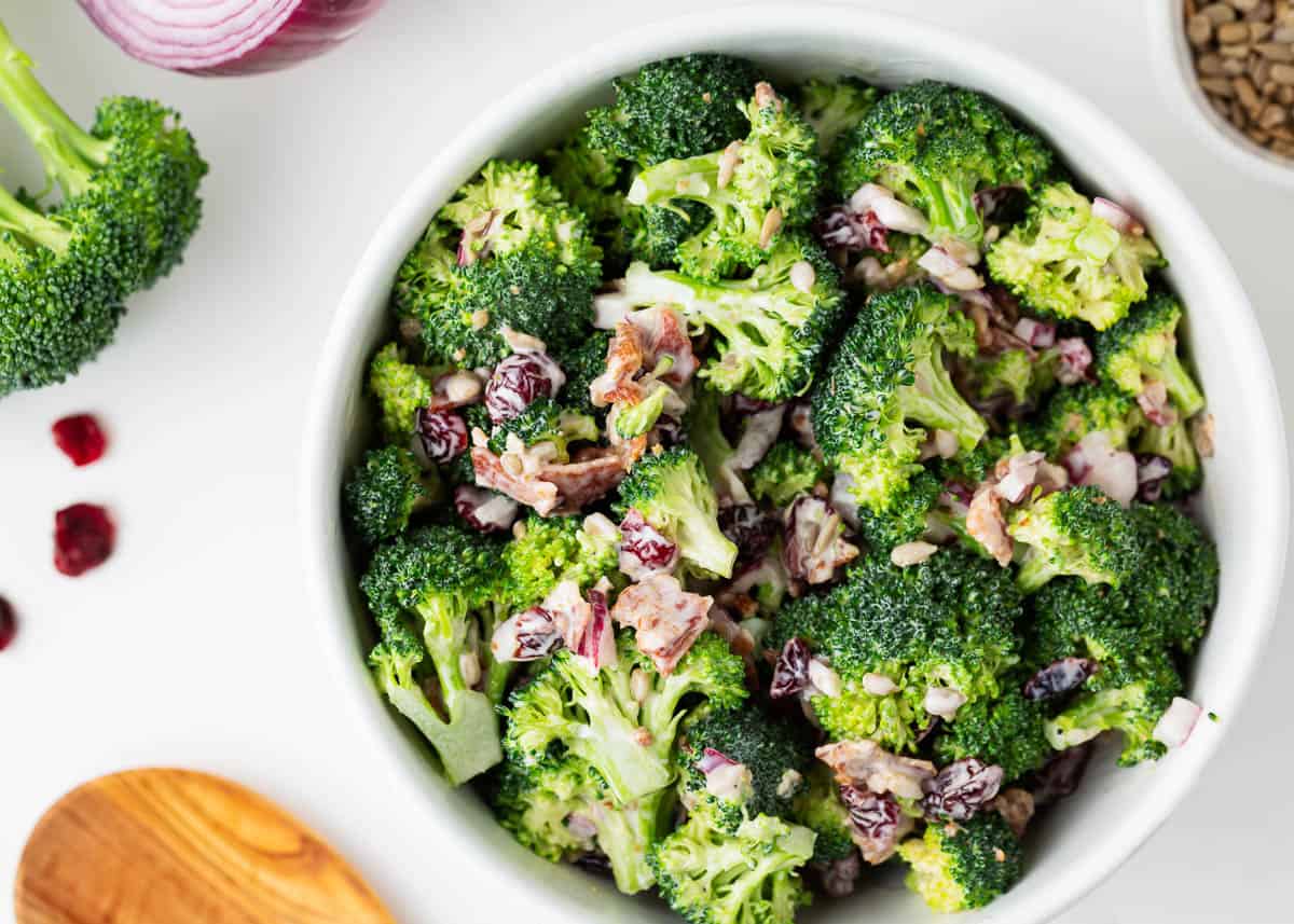 Broccoli salad in a white bowl.