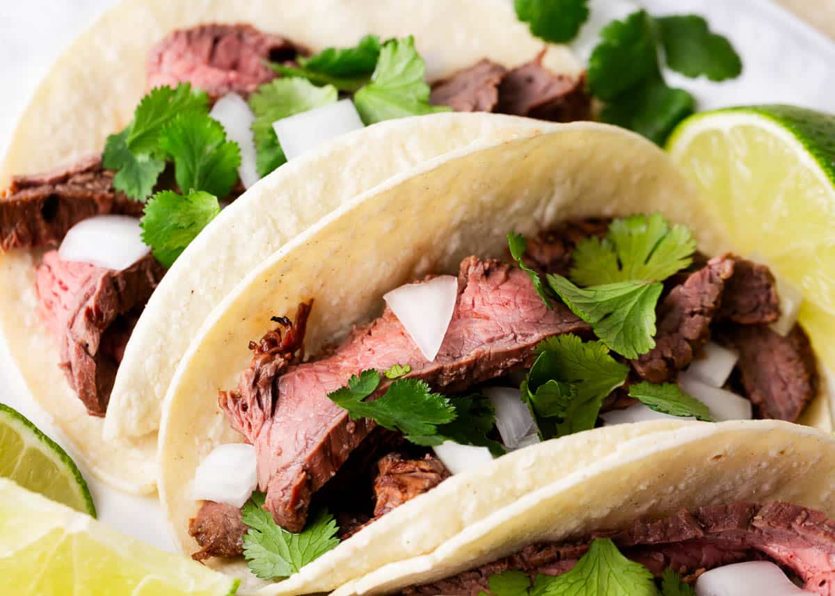 Carne asada tacos on plate.