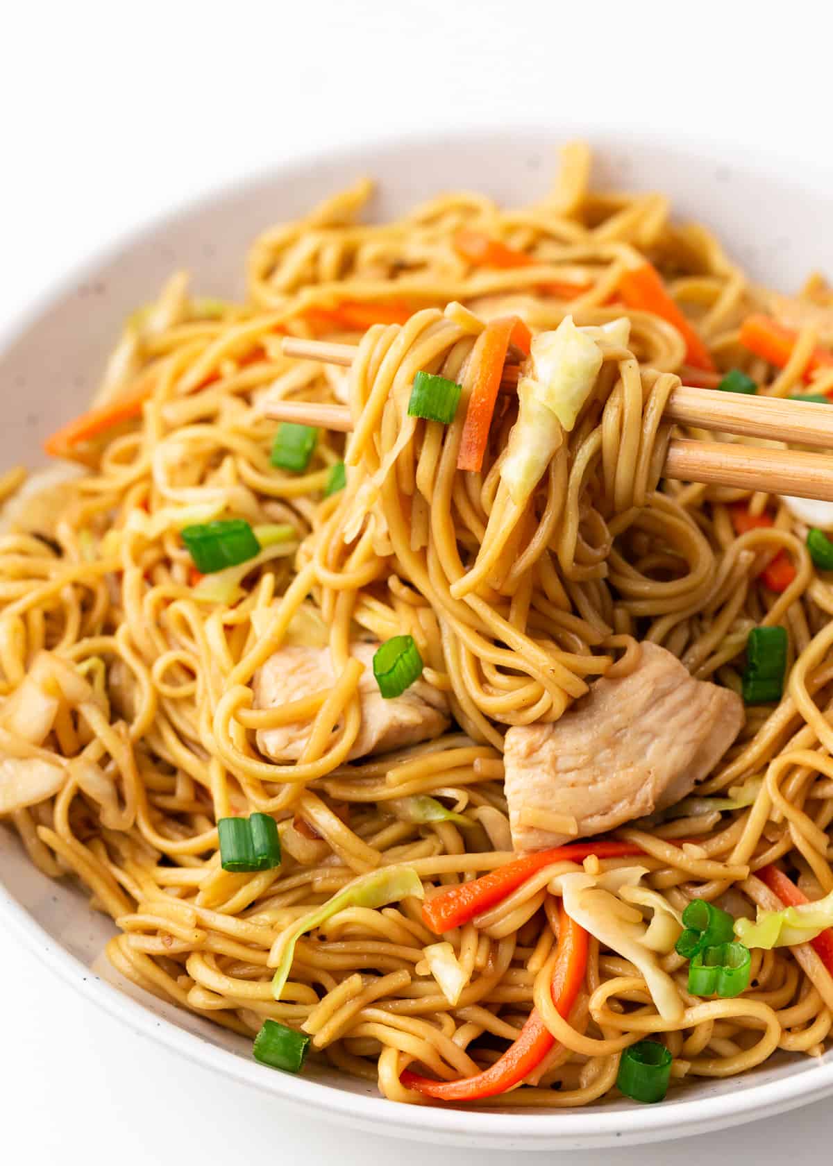 Chicken chow mein in a white bowl. 