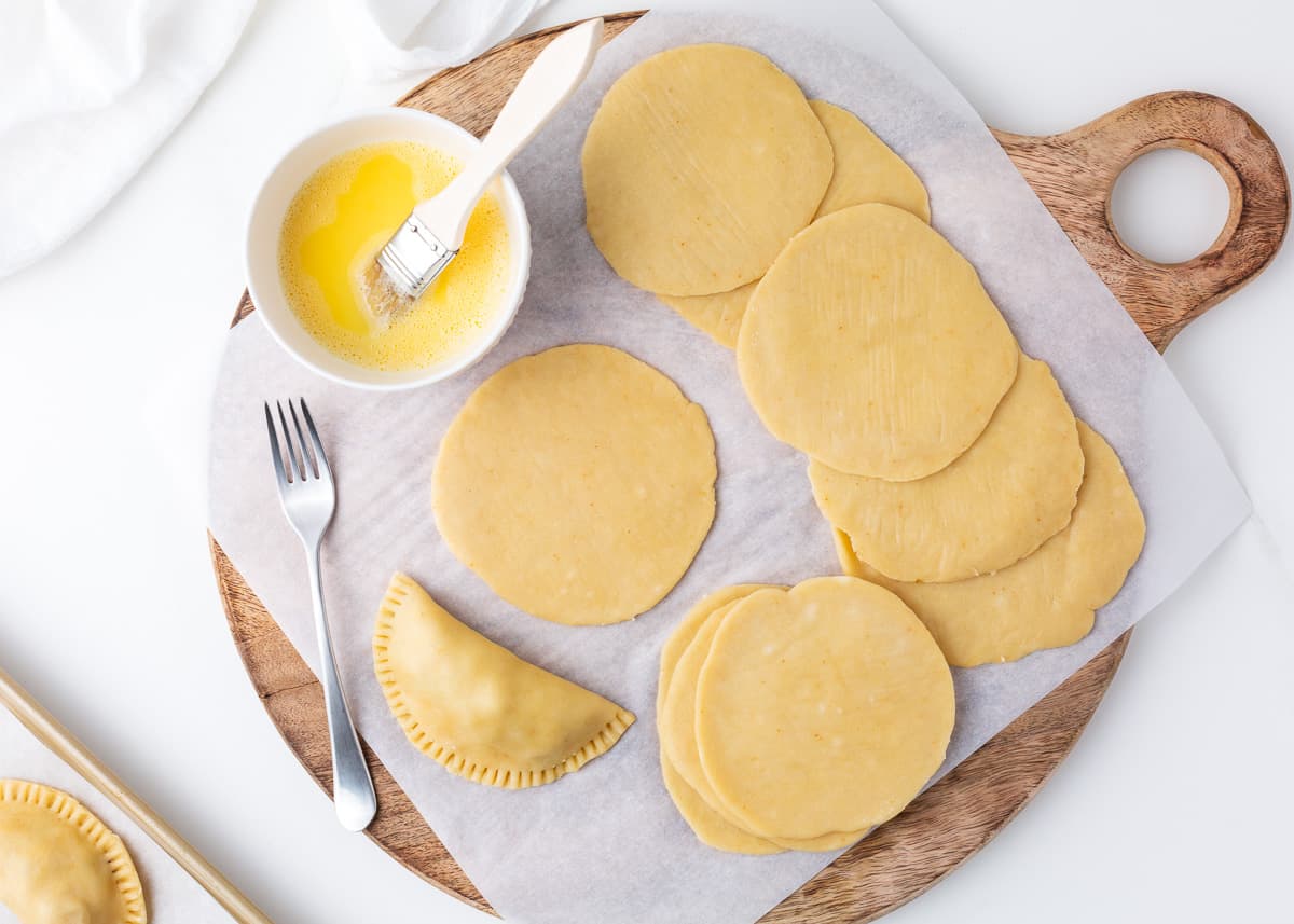 Empanada dough recipe on wooden board.