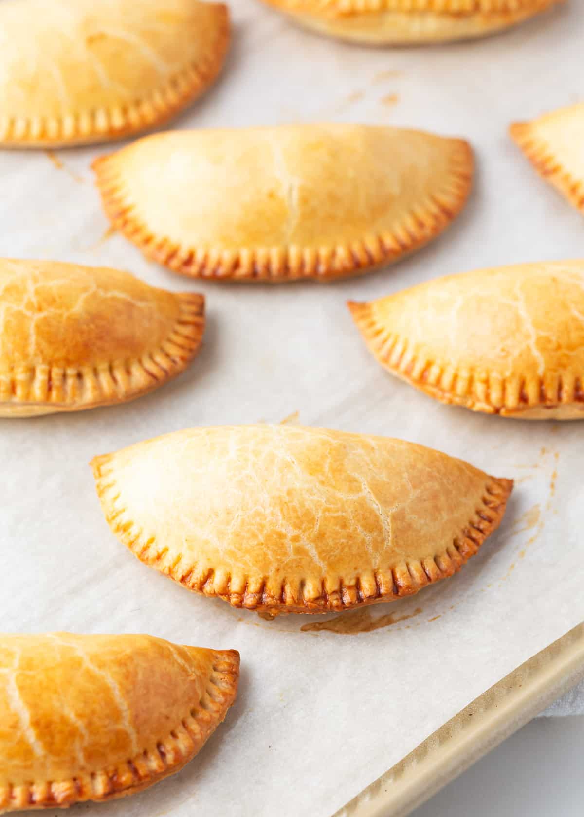 Baking empanadas on a baking sheet.