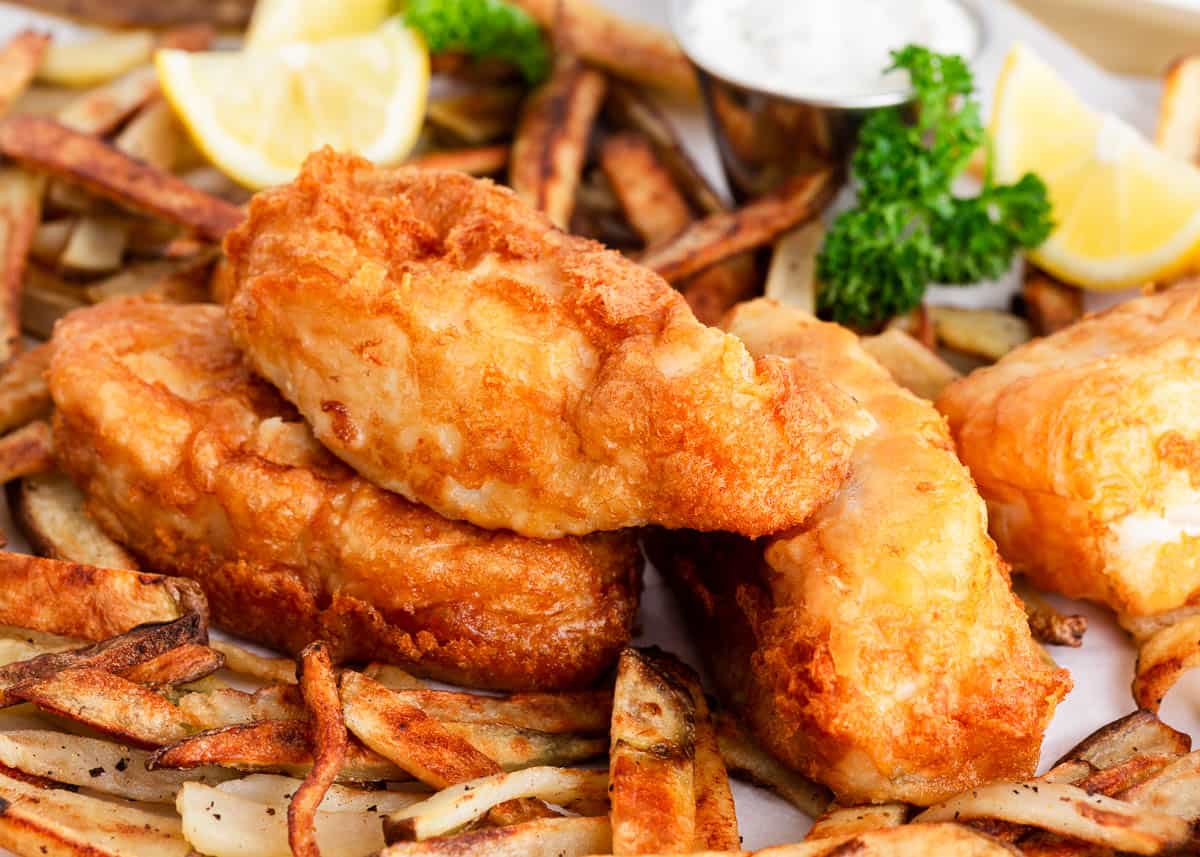 Fish and chips on a piece of parchment paper.