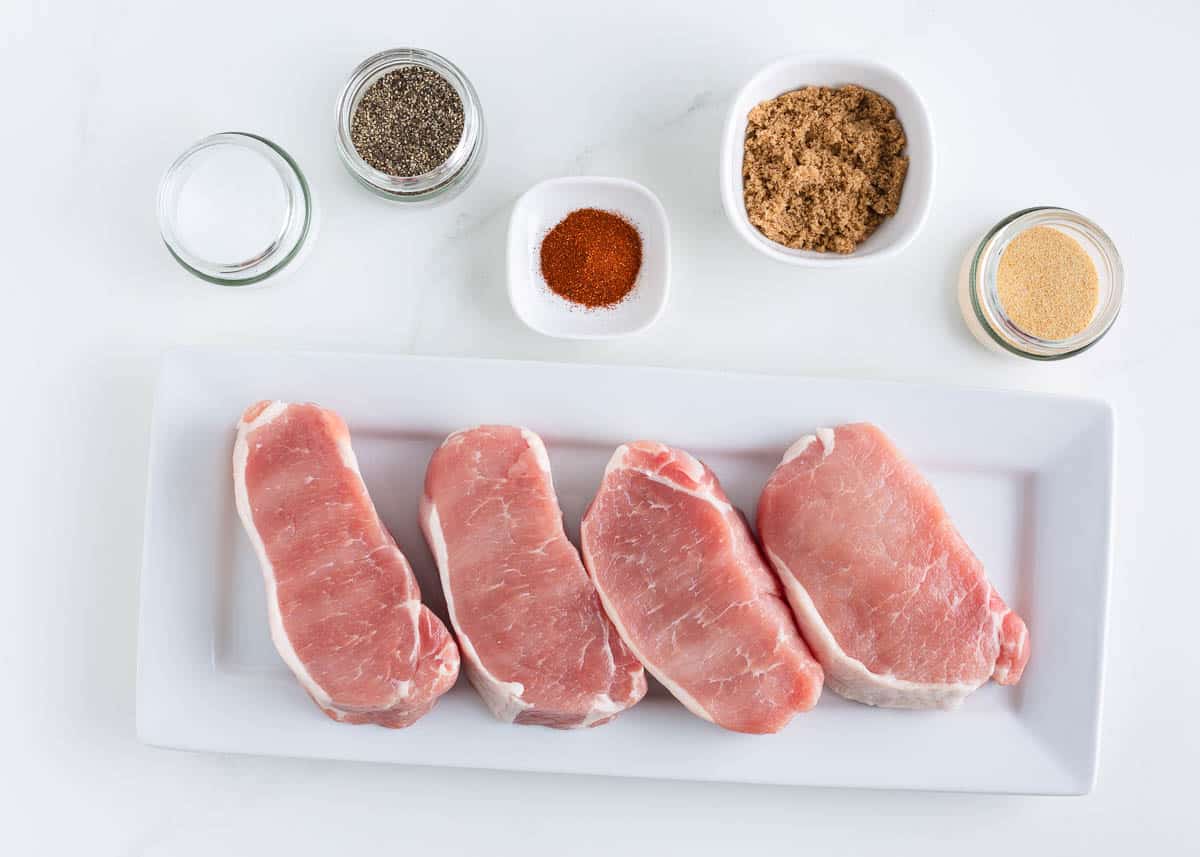 Grilled pork chop ingredients on counter.