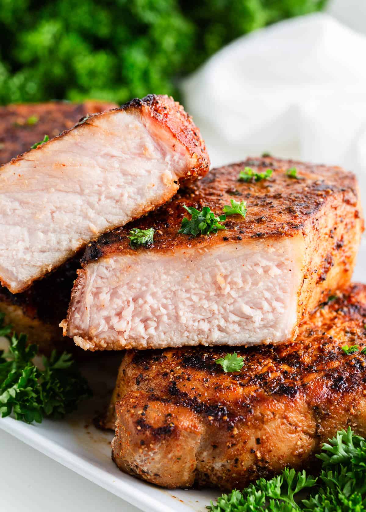 Cut grilled pork chops on a plate.
