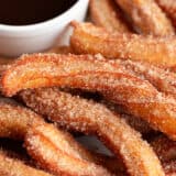 Homemade churros on a plate.