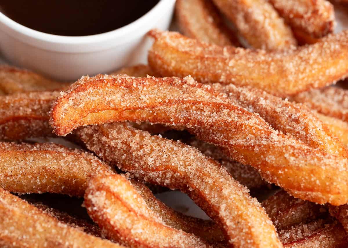 Homemade churros on a plate.