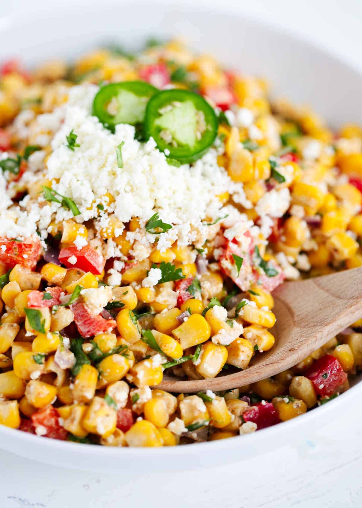 Mexican street corn salad in a white bowl.