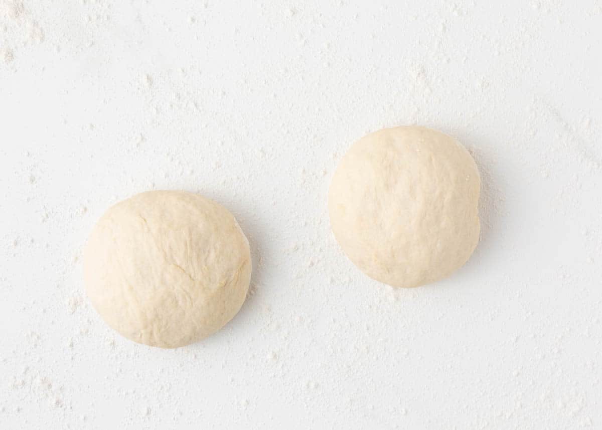 Pizza dough balls on counter.