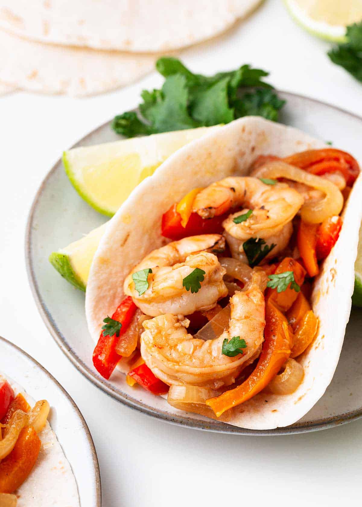 Shrimp fajita taco on a plate.