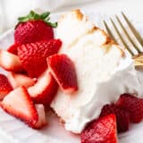 Slice of strawberry short cake on a plate.