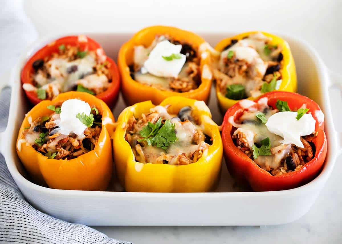 Chicken stuffed peppers with white dish. 