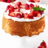 Strawberry shortcake on a white cake stand.