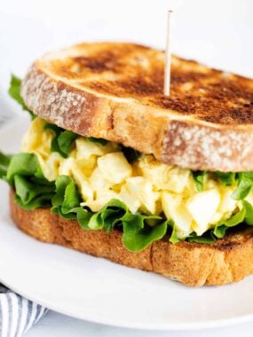 Egg salad sandwich on a plate.