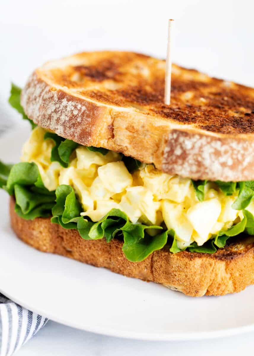 Egg salad sandwich on a plate.