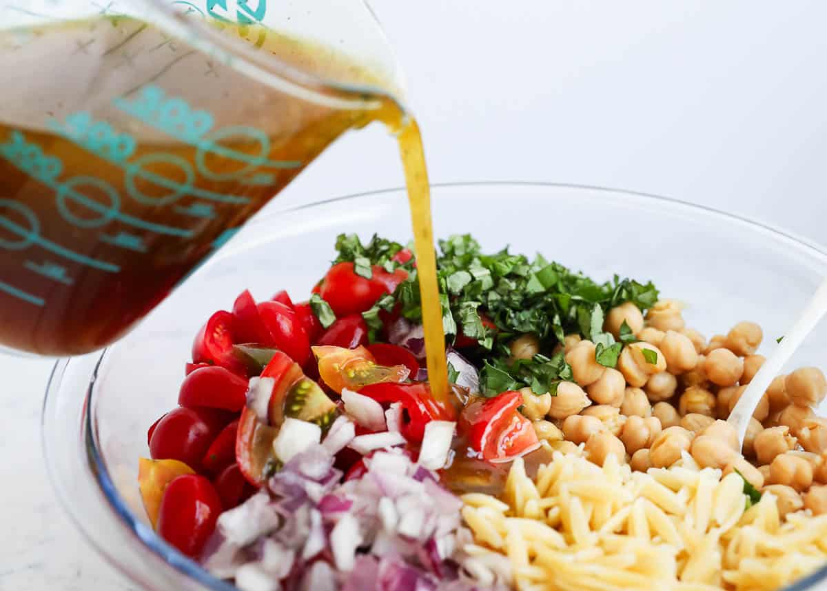 Pour dressing over orzo salad.