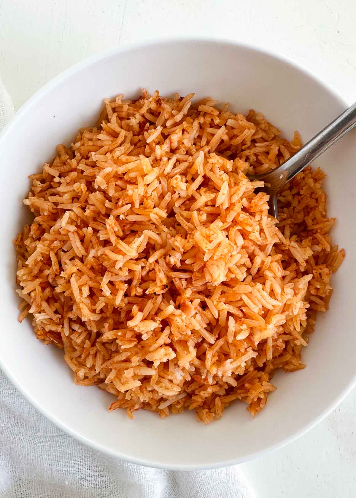 Mexican rice in a bowl with spoon.