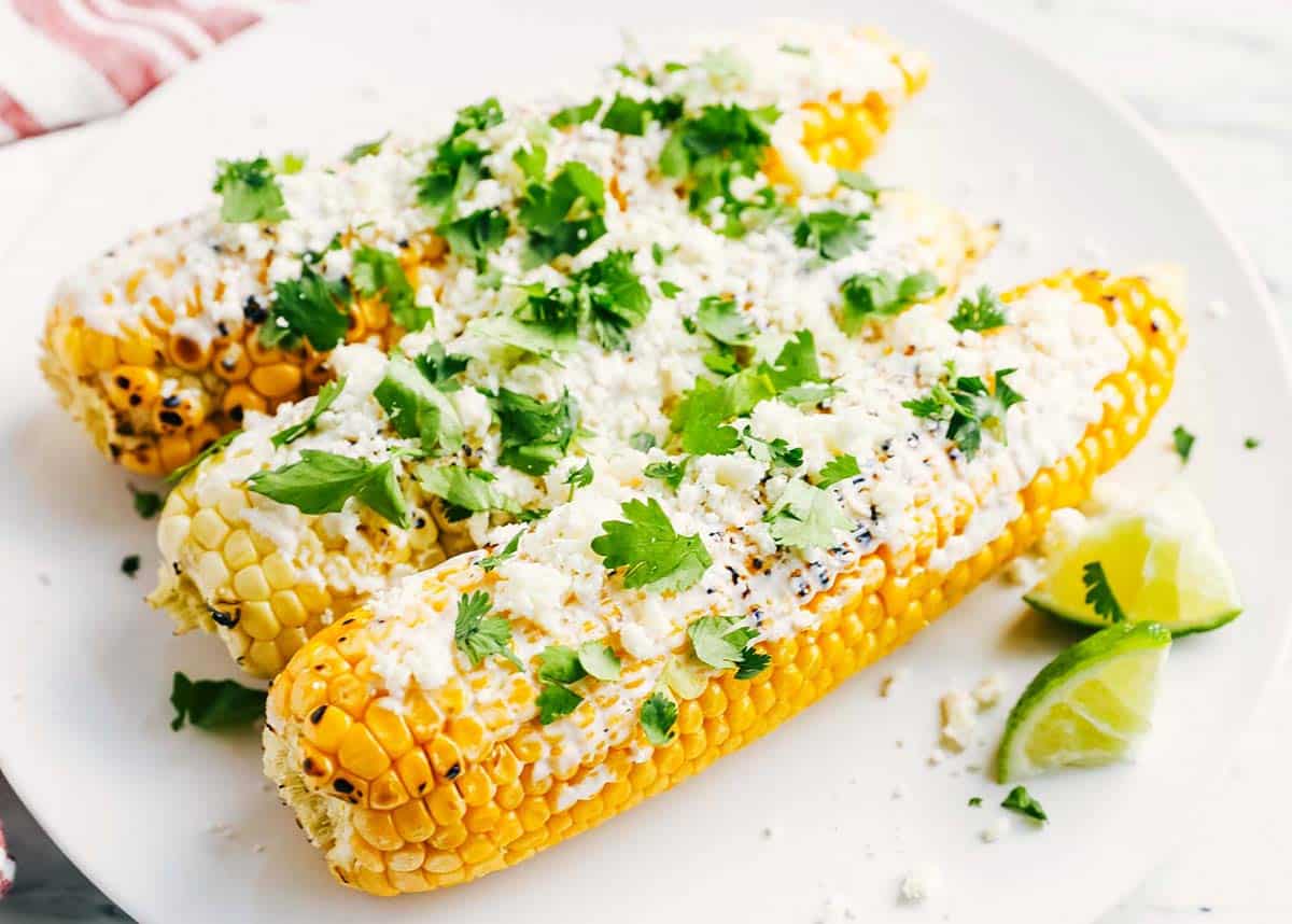 Mexican street corn on a white plate. 