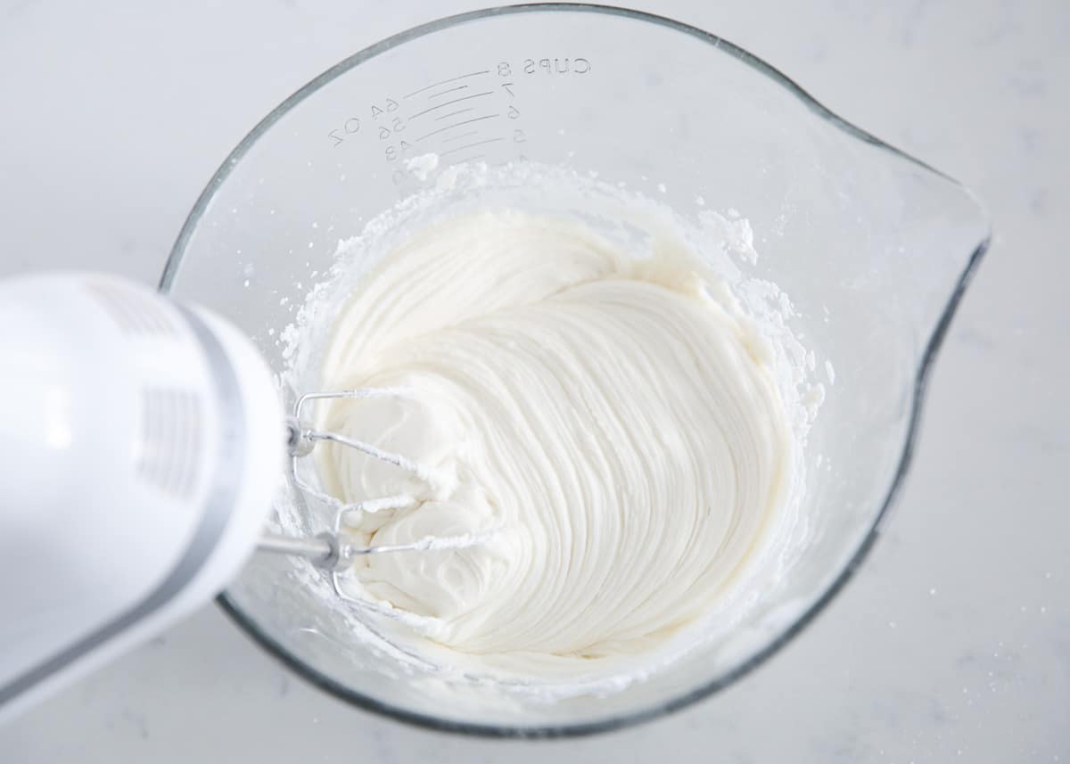 Mixing frosting in bowl.