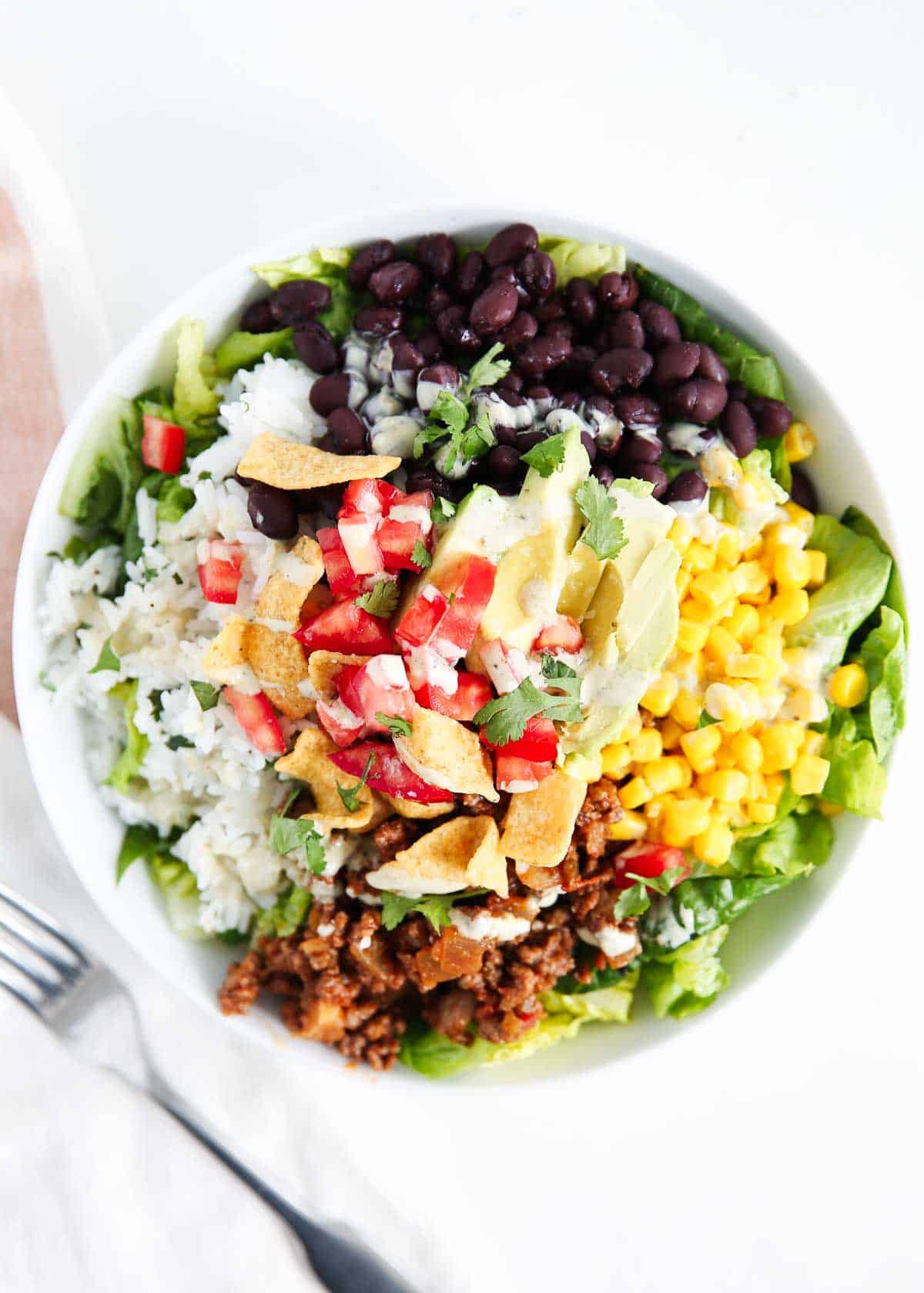 Taco salad in a white bowl.