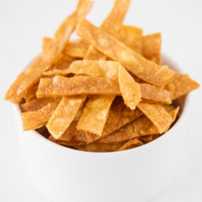 Homemade tortilla strips in a bowl.