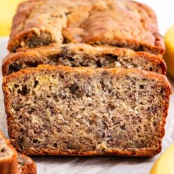 Sliced banana bread on parchment paper.