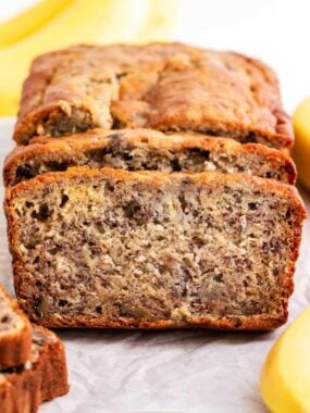 Sliced banana bread on parchment paper.