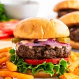 Hamburger and fries on a plate.