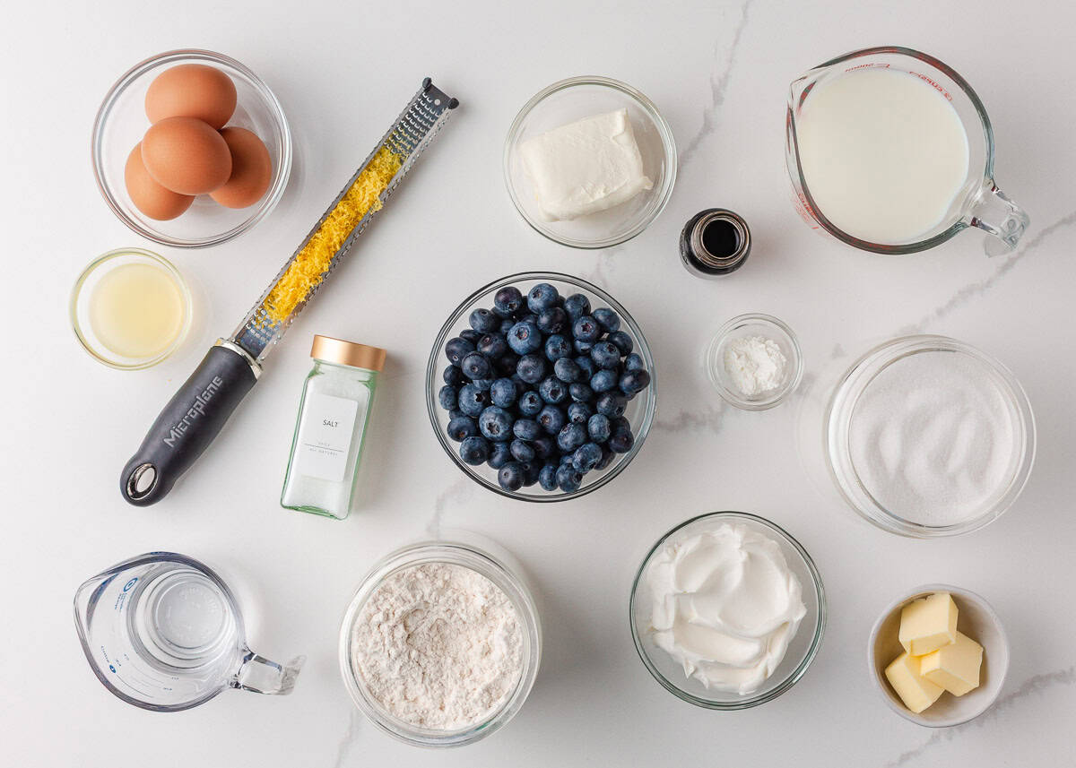 Blueberry crepes filled with luscious cream cheese crepe filling made with whipped cream and a delicious blueberry sauce are so good it's almost sinful. Is it breakfast? Is it dessert? It is most definitely both! Ingredients for blueberry crepes including flour, eggs, milk, blueberries, sugar, butter, and lemon zest.