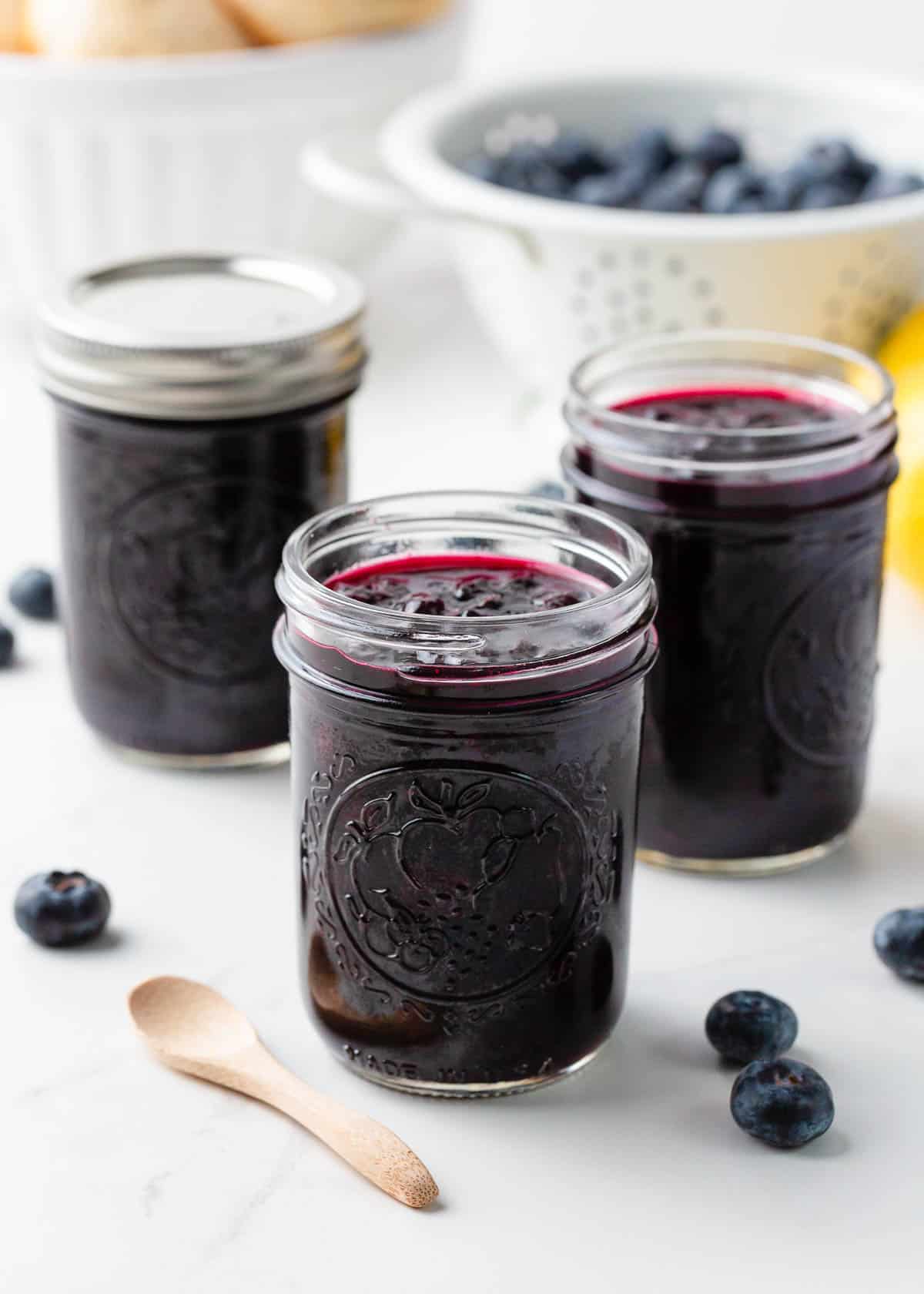 Three jars of blueberry jam.