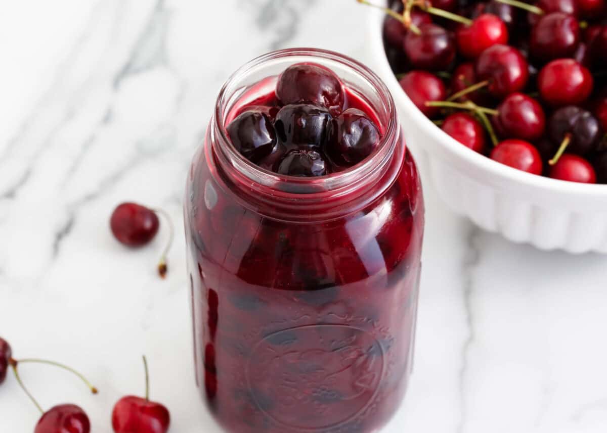 Cherry pie filling in a glass jar.