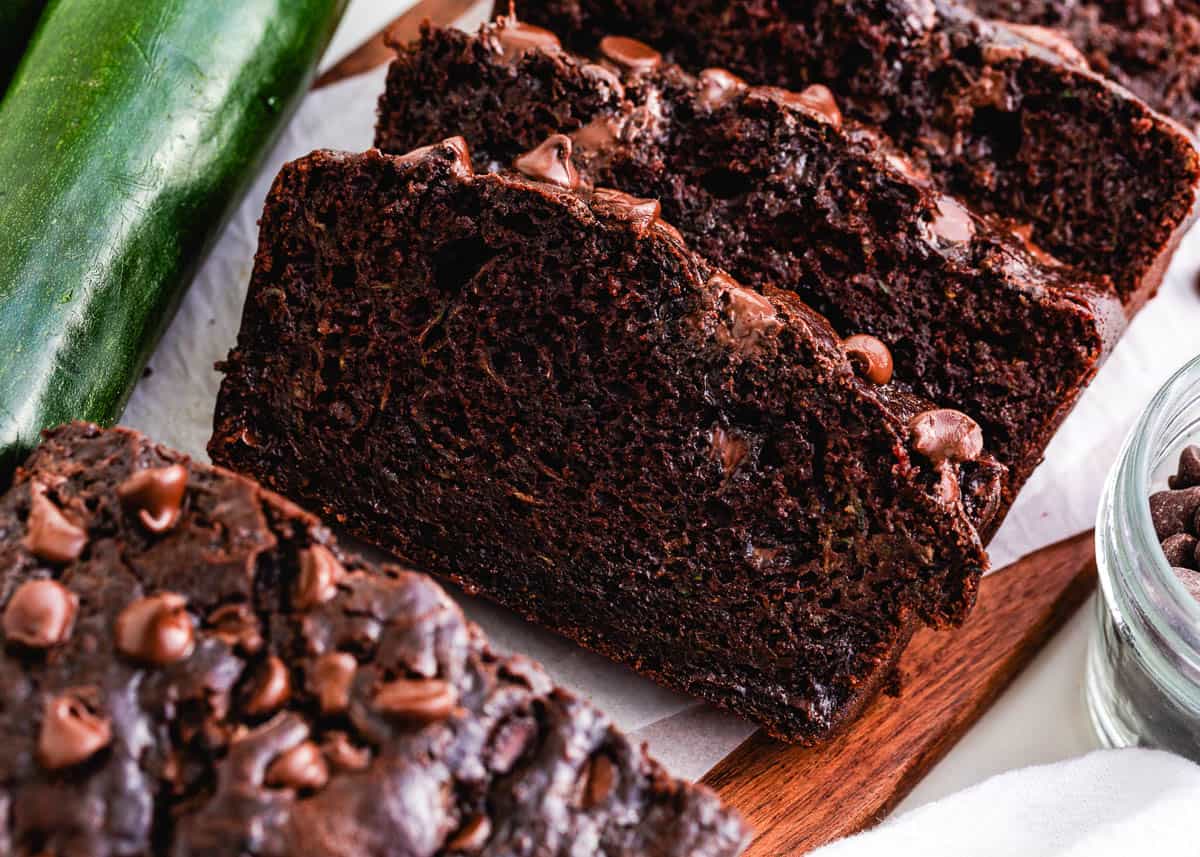 Sliced chocolate zucchini bread on board.