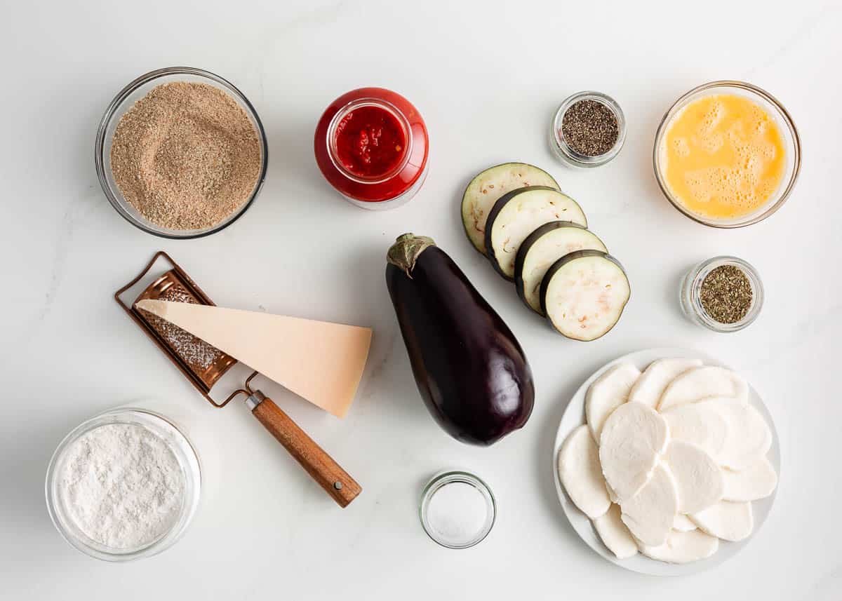 Eggplant parmesan ingredients on the counter.