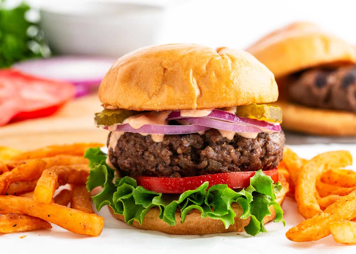 Hamburger and fries on a platter.