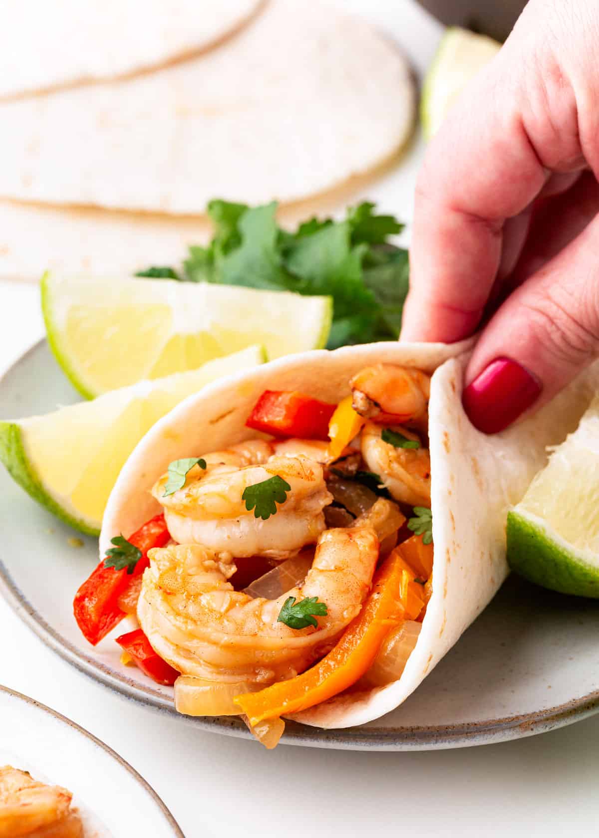 Shrimp fajitas rolled up in a soft taco shell.