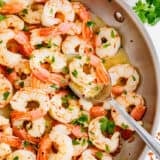 Cooking shrimp scampi in a pot.