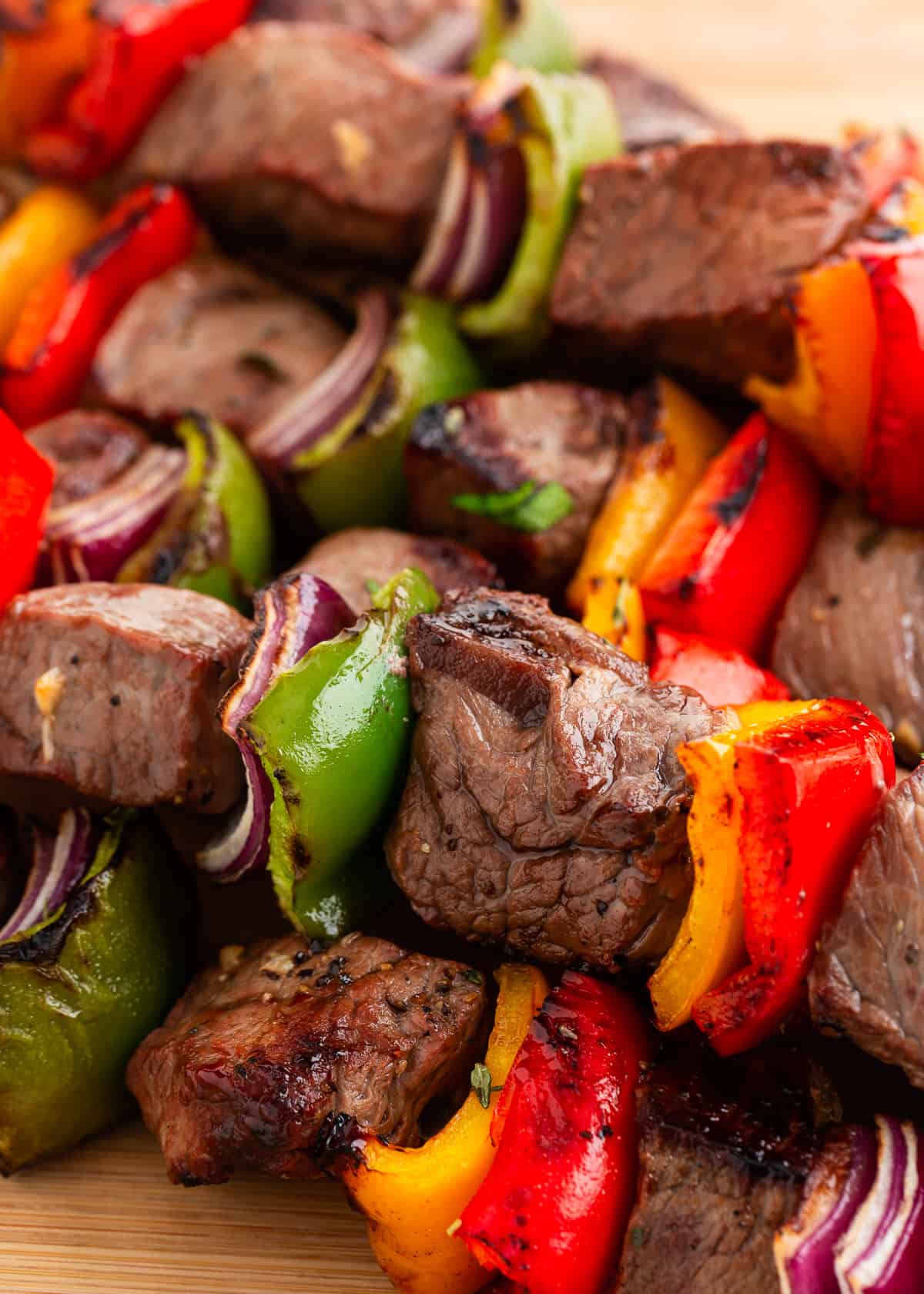 Steak kabobs stacked on platter.