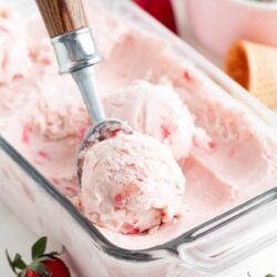 Scooping strawberry ice cream.