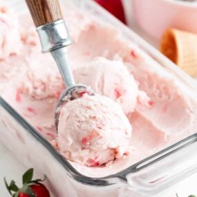 Scooping strawberry ice cream.