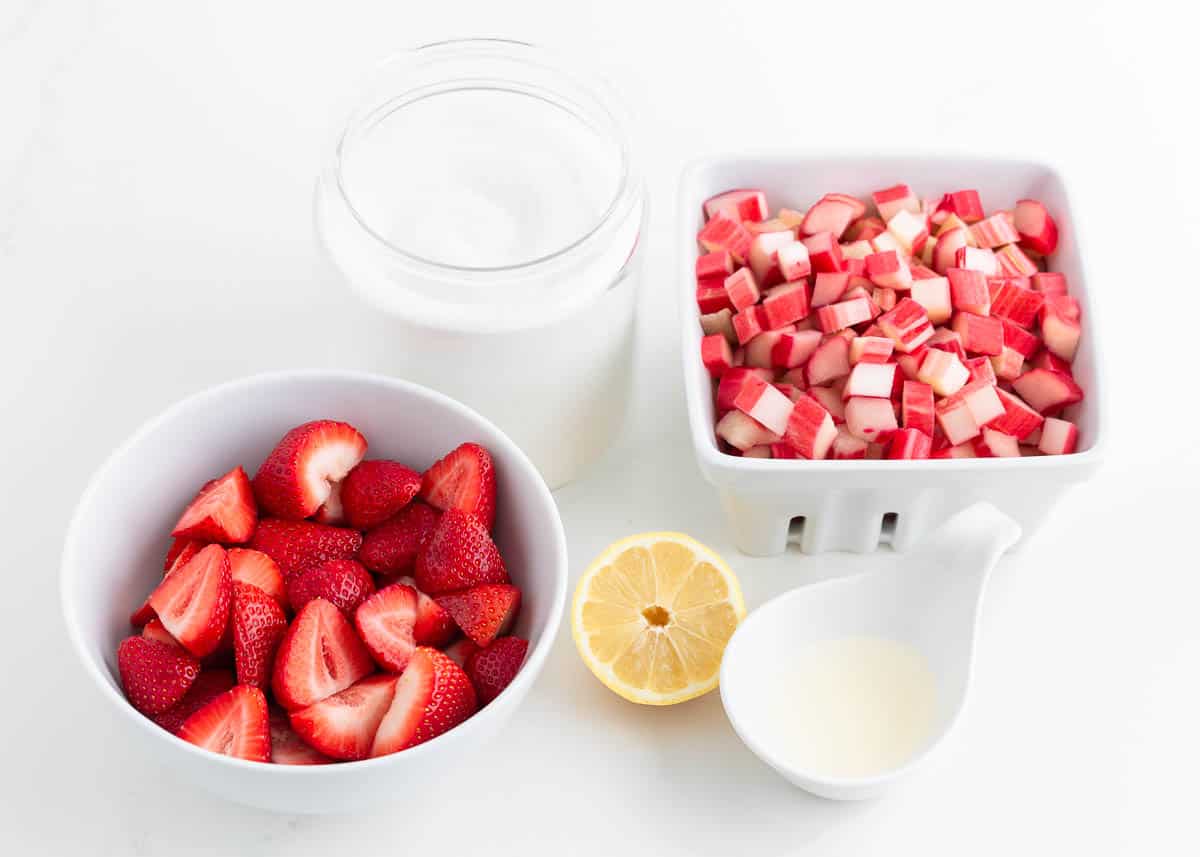 Strawberry rhubarb jam ingredients on counter.