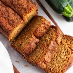 Sliced zucchini bread on a cutting board.