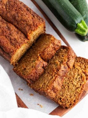 Overhead view of a sliced loaf of zucchini bread on the counter, arranged in a vertical layout.