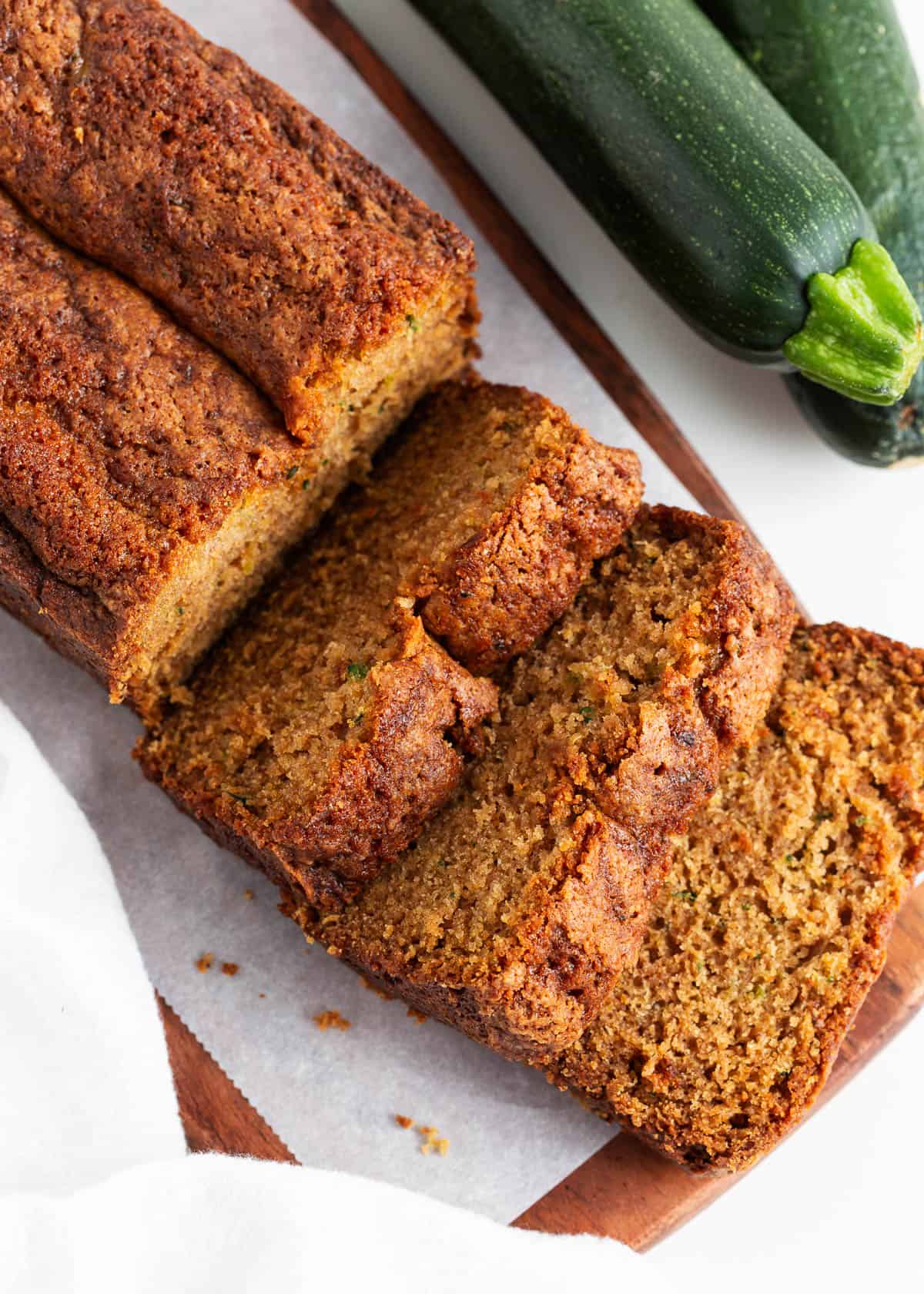 Sliced zucchini bread on a cutting board.