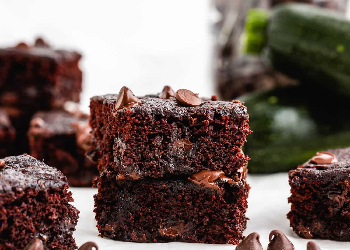 Stacked zucchini brownies on counter.