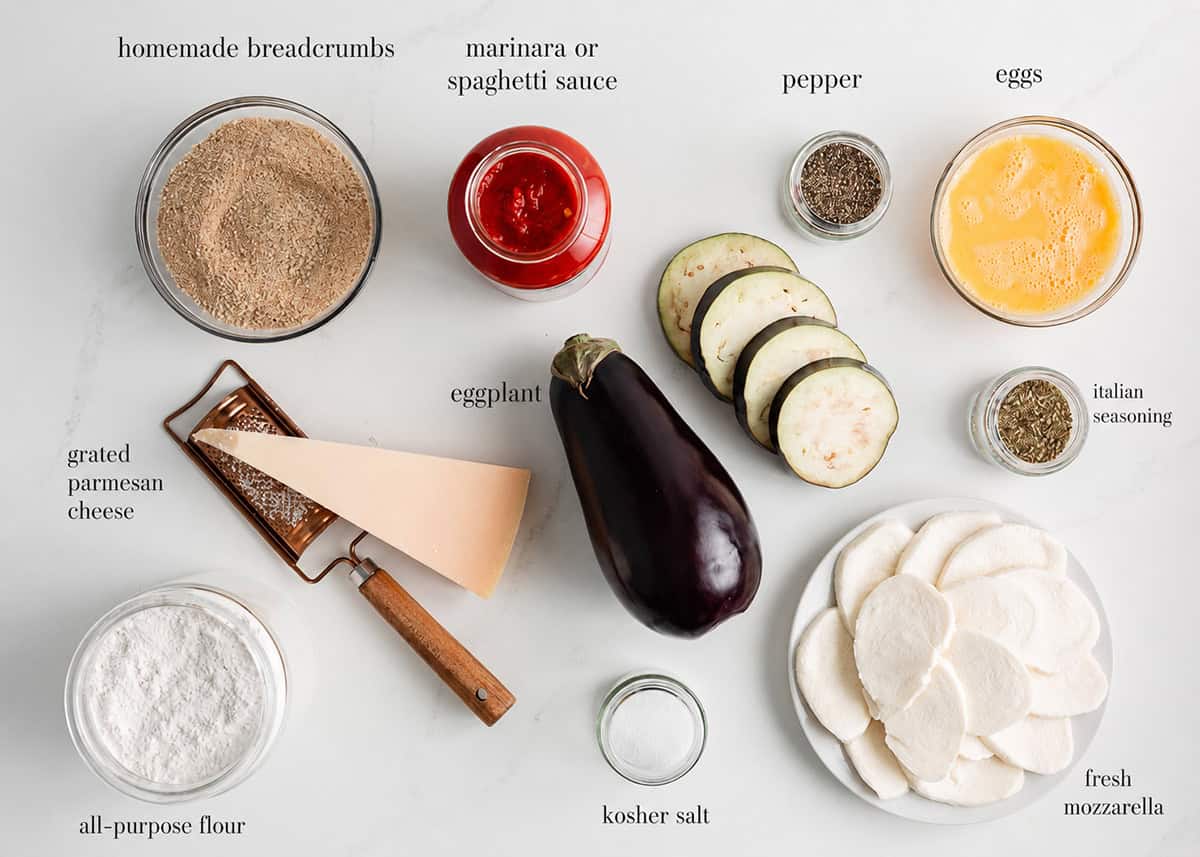 Bring the taste of Italy to your kitchen table with this easy baked eggplant parmesan recipe! Made with layers of crispy coated eggplant, flavorful marinara sauce, and fresh mozzarella cheese! Eggplant Parmesan ingredients including eggplant, breadcrumbs, flour, eggs, marinara sauce, fresh mozzarella, Parmesan, Italian seasoning, salt and pepper.