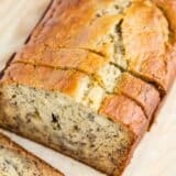 Sliced banana bread on a wooden board.